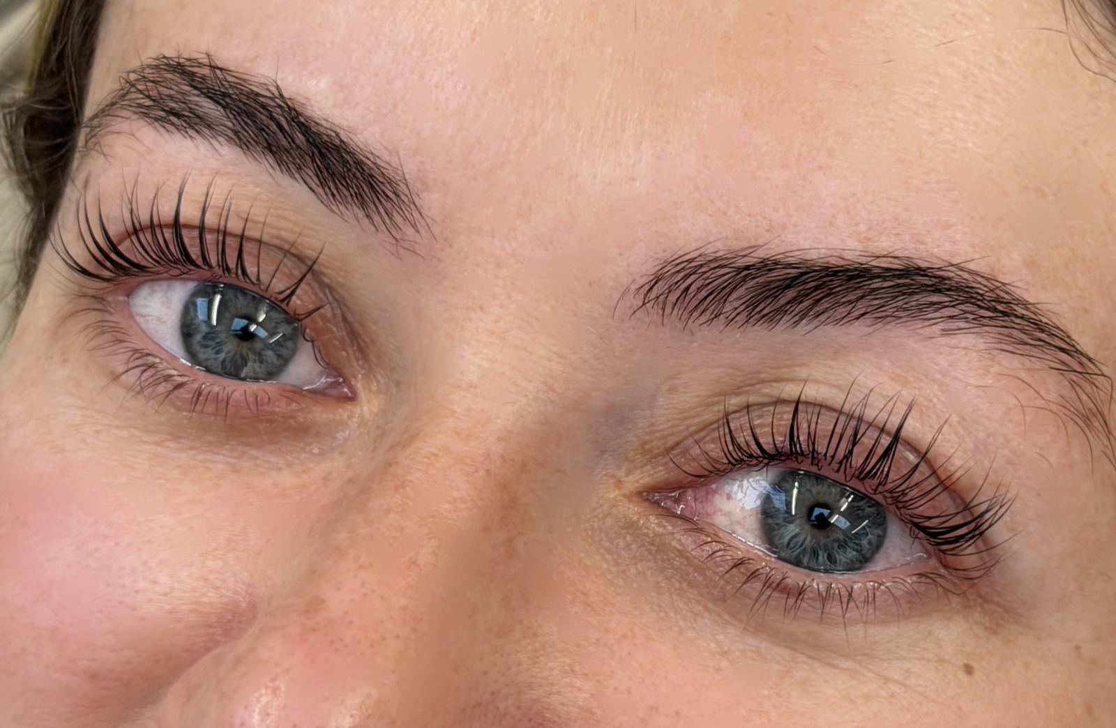 Close-up of beautifully shaped brows and lifted, tinted lashes